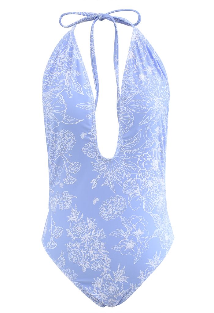 Fato de banho aberto nas costas com desenho floral em azul